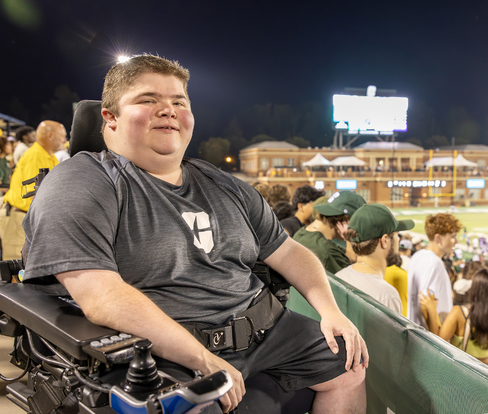 Bryson Foster sits at the top of the bleachers during a home football game.